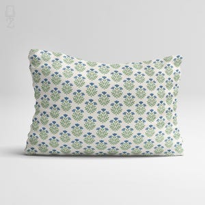 Professional studio shot of a blue wildflower chenille pillow cover on a clean white background, showcasing the repeating block print pattern.