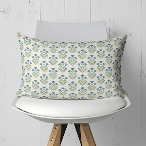 Rectangular blue floral lumbar pillow cover on a white designer chair, perfect for back support and aesthetic office decor.