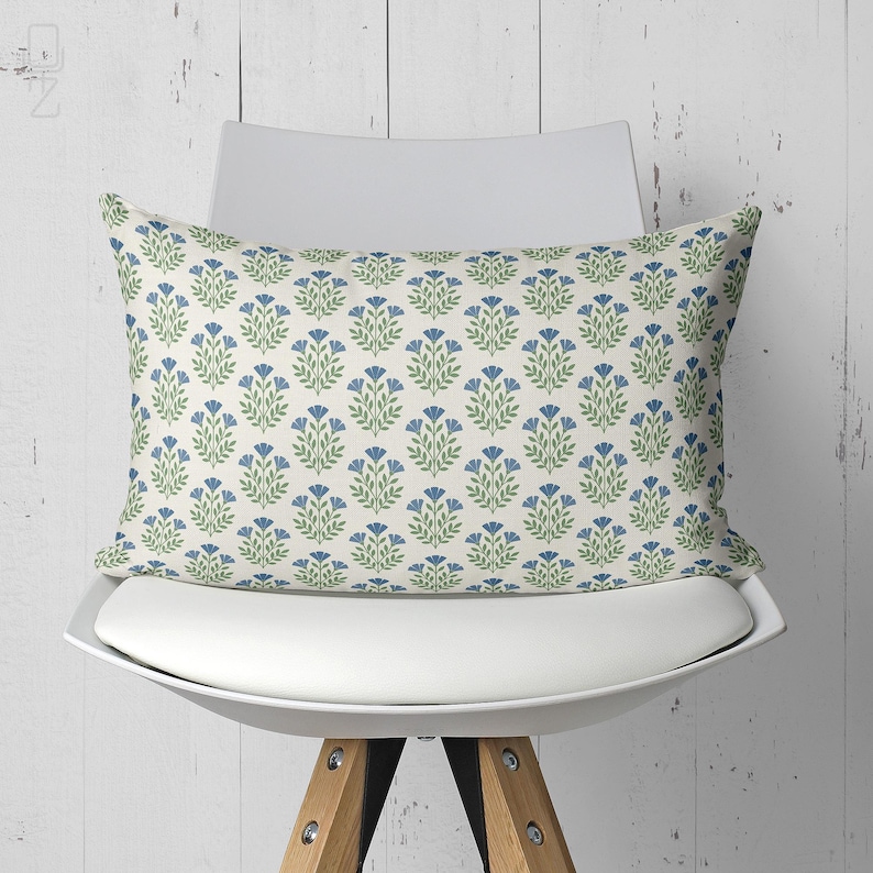 Rectangular blue floral lumbar pillow cover on a white designer chair, perfect for back support and aesthetic office decor.