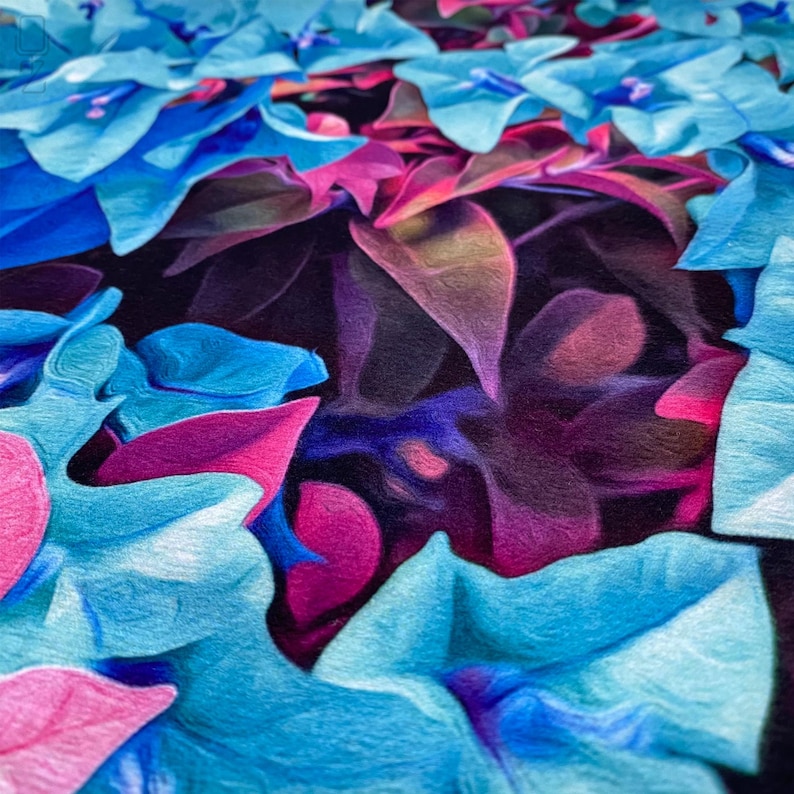 May include: Close-up of a vibrant floral arrangement featuring blue and pink flowers with a dark purple background. The flowers are arranged in a layered pattern, creating a sense of depth and texture.