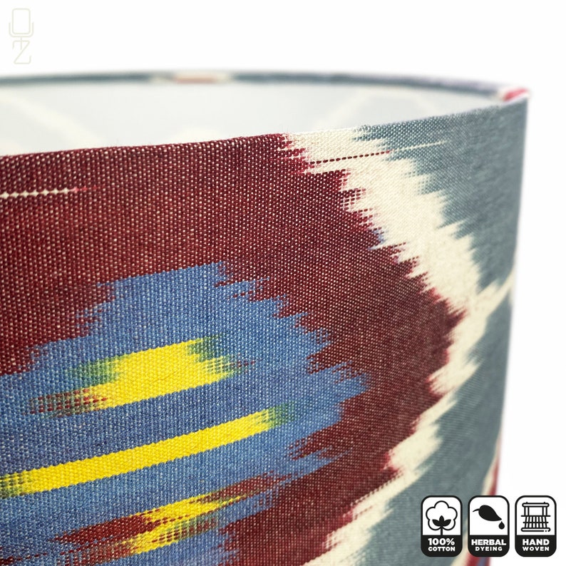 May include: A close-up of a lampshade with a colorful ikat pattern. The lampshade is made of 100% cotton, hand-woven, and herbally dyed.