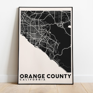 May include: Black and white map print of Orange County, California. The map shows the roads and streets of the county. The text "ORANGE COUNTY CALIFORNIA" is printed below the map.