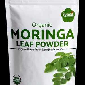 May include: A white resealable pouch with a green label that reads "Organic Moringa Leaf Powder" and "Vegan. Gluten-Free. Superfood. Non-GMO". The pouch also features a USDA Organic seal and a green leaf illustration. The pouch contains 1 pound (454 grams) of moringa leaf powder.