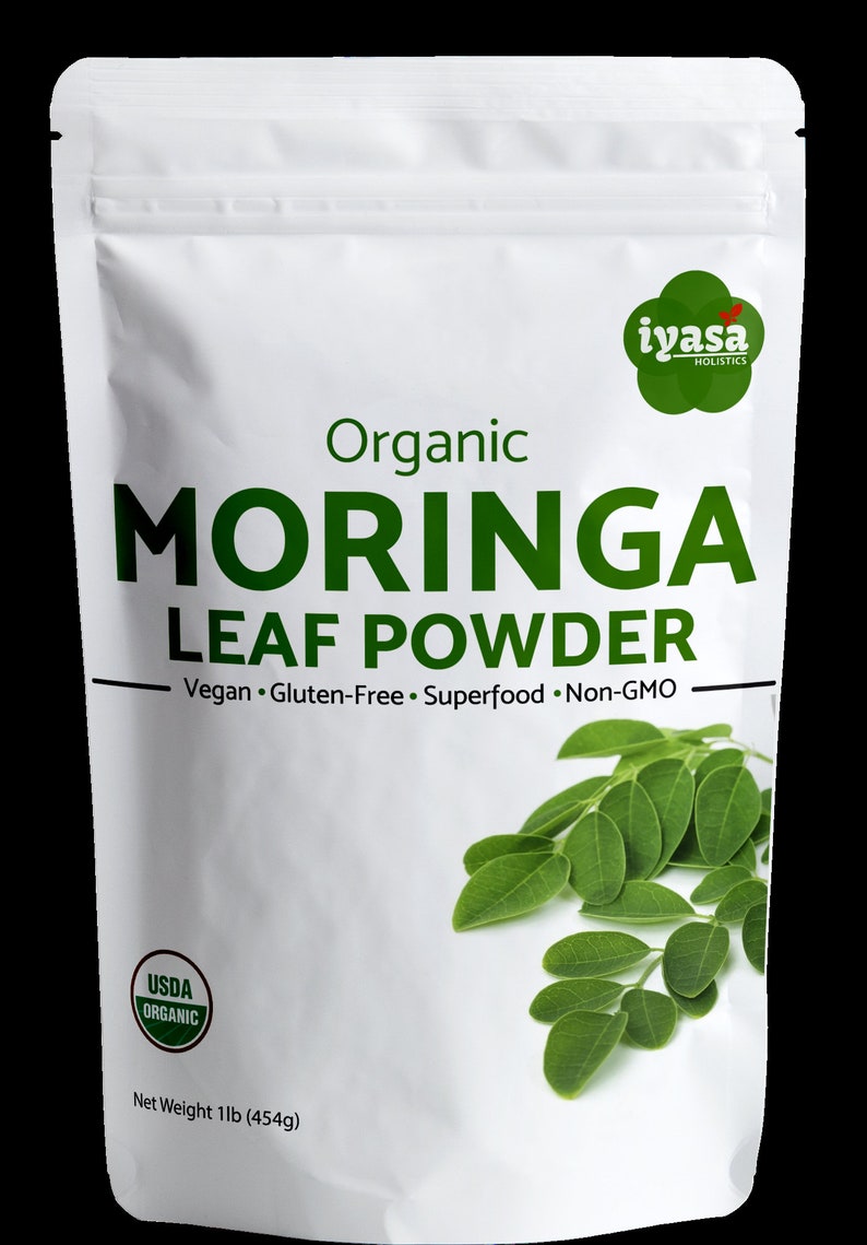 May include: A white resealable pouch with a green label that reads "Organic Moringa Leaf Powder" and "Vegan. Gluten-Free. Superfood. Non-GMO". The pouch also features a USDA Organic seal and a green leaf illustration. The pouch contains 1 pound (454 grams) of moringa leaf powder.
