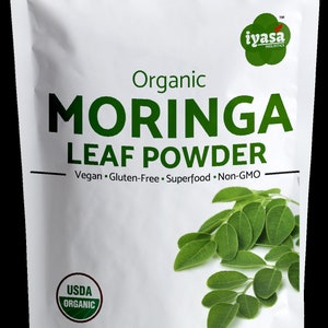 May include: A white pouch with a green and white label that reads "Organic Moringa Leaf Powder". The label also includes the text "Vegan. Gluten-Free. Superfood. Non-GMO" and a USDA Organic seal. The pouch contains 8 ounces (226 grams) of moringa leaf powder.