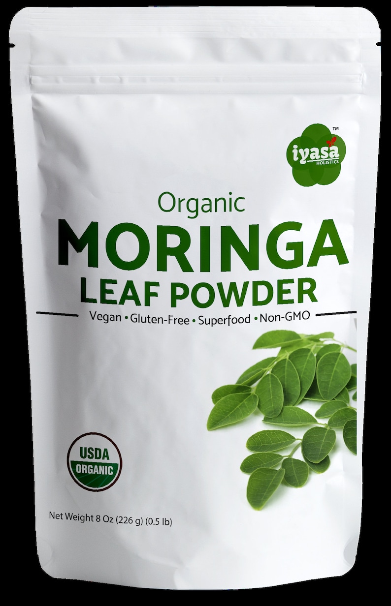 May include: A white pouch with a green and white label that reads "Organic Moringa Leaf Powder". The label also includes the text "Vegan. Gluten-Free. Superfood. Non-GMO" and a USDA Organic seal. The pouch contains 8 ounces (226 grams) of moringa leaf powder.