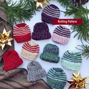 May include: A collection of ten hand-knitted hats in various colors and patterns, including red, white, blue, green, and purple. The hats are arranged on a white surface with some greenery and gold ornaments. Knitting Pattern.