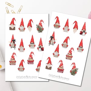 May include: Two sticker sheets showcasing festive gnomes with red hats and white beards. The gnomes are depicted with cameras, books, and gifts. The stickers are labelled "Jellyfish Stickers - handmade stickers with love."