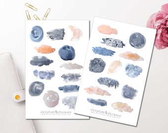 May include: Two sheets of stickers featuring abstract shapes in watercolour-style designs. The shapes are in shades of blue, grey, and peach. The stickers are labelled "Jellyfish Stickers" and include the website address "www.jellyfishstickers.etsy.com".