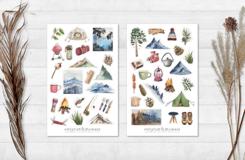 May include: Two sheets of stickers featuring watercolor illustrations of camping and nature scenes. The stickers include images of mountains, trees, tents, campfires, a lantern, a mug, a grill, a sleeping bag, a fishing rod, a knife, a marshmallow, a hat, boots, and more. The stickers are labeled "Jellyfish Stickers" and "Handmade Stickers with Love."