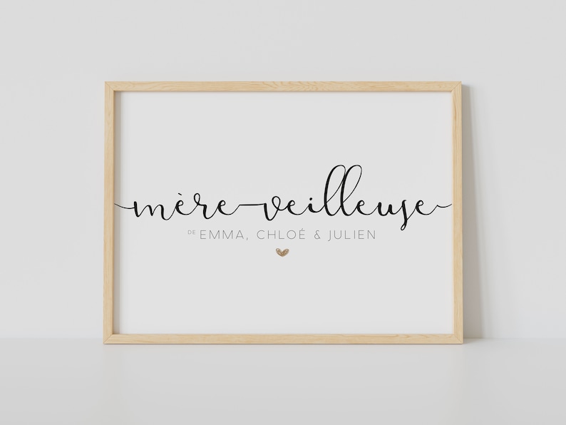 May include: A framed print with the text "m&egrave;re veilleuse" in black cursive script. Below the text, it reads "de Emma, Chlo&eacute; & Julien" in smaller font. A small gold heart is centered below the names.