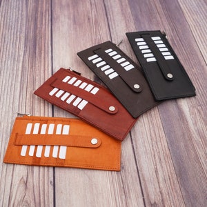Cartera larga para mujer de AG Wallets con bolsillo lateral con cremallera y cierre a presión de piel de vaca negra