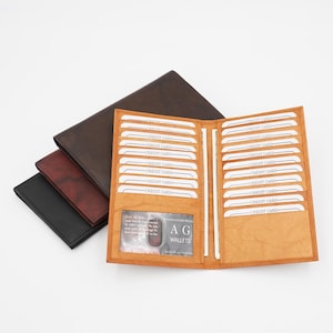 Cartera larga AG Wallets RFID de cuero premium para tarjetas de crédito, con capacidad para hasta 20 tarjetas y dos ranuras laterales para efectivo.