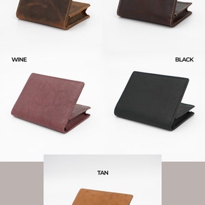 May include: Five leather wallets in different colors: hunter brown, vintage brown, wine, black, and tan. Each wallet is folded in half and has a stitched edge.