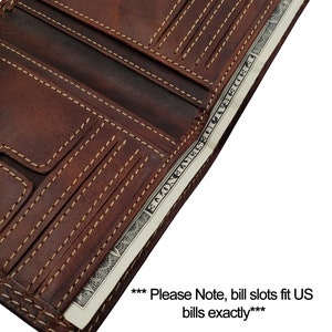 May include: A brown leather trifold wallet with multiple card slots and a bill compartment. The wallet is open and a US dollar bill is visible inside. The text "*** Please Note, bill slots fit US bills exactly***" is visible below the wallet.