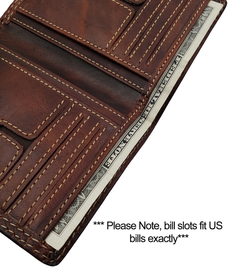 May include: A brown leather trifold wallet with multiple card slots and a bill compartment. The wallet is open and a US dollar bill is visible inside. The text "*** Please Note, bill slots fit US bills exactly***" is visible below the wallet.
