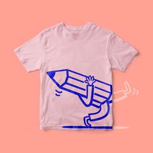 May include: A pale pink t-shirt with a blue cartoon pencil design. The pencil has arms and legs and is depicted running, with one leg extended and a trail. The design is centrally placed on the shirt.