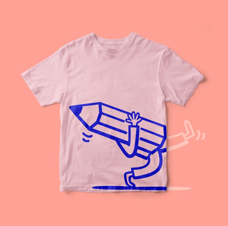 May include: A pale pink t-shirt with a blue cartoon pencil design. The pencil has arms and legs and is depicted running, with one leg extended and a trail. The design is centrally placed on the shirt.