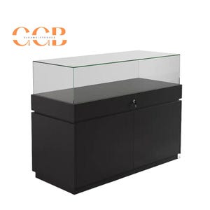 May include: Black display case with a glass top and a lockable drawer. The case has two doors on the bottom and is made of wood.