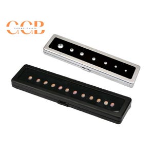 May include: Two rectangular jewellery boxes. One is black with small, round, light-coloured stones. The other is silver with a black centre and clear, round stones of varying sizes. The boxes are closed.