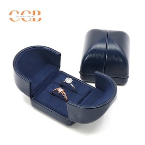 Boîte à bijoux double ouverte bleue en cuir synthétique polyuréthane de qualité supérieure, boîte à alliances, boîte à boucles d'oreilles, boîte à collier, boîte à bagues pour propositions, étui à bagues à double fente
