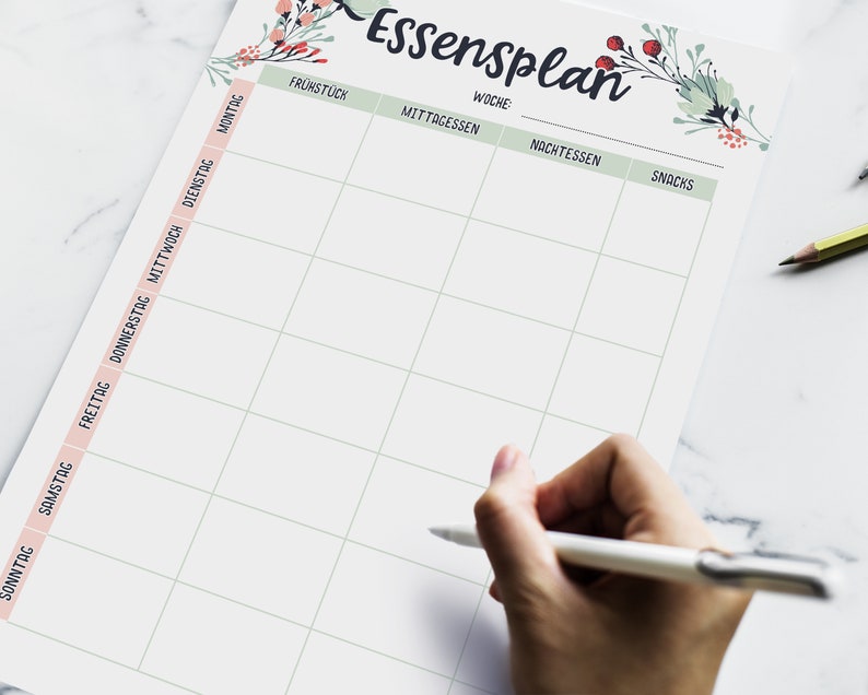 May include: A weekly meal planner with a floral design. The planner has columns for breakfast, lunch, dinner, and snacks. The days of the week are listed on the left side of the planner.