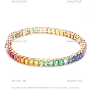 May include: A gold bracelet with a rainbow of rectangular gemstones. The bracelet is made of 14k gold and features a total of 2.5 carats of gemstones.