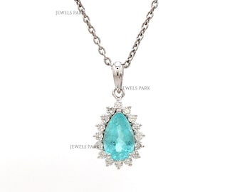May include: A silver necklace with a pear-shaped, light blue gemstone pendant. The pendant is surrounded by small, clear stones, and the chain is a delicate link style. The text "JEWELS PARK" is visible on the image.