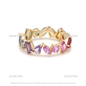 May include: A gold band ring with a rainbow of colorful gemstones. The ring features a variety of shapes and sizes of gemstones, including round, oval, and pear-shaped.