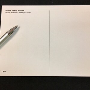 May include: A white postcard with the text "Quartier Villeray, Montreal" and "Photo &copy; R. Le Corre / Jazzikproductions" printed on the front. The back of the postcard is blank with a vertical line down the center. The text "CP17" is printed in the bottom left corner.