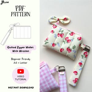May include: A PDF pattern for a quilted zipper wallet with wristlet. The image shows a finished wallet, wristlet, and bow, all with a strawberry print on a cream background. The text on the image says "Beginner Friendly" and "Video Tutorial".