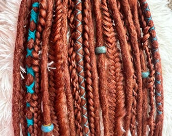 A set of long, auburn colored SE synthetic dreadlocks with turquoise accents, synthetic hair arranged in twists, braids, and loose curls