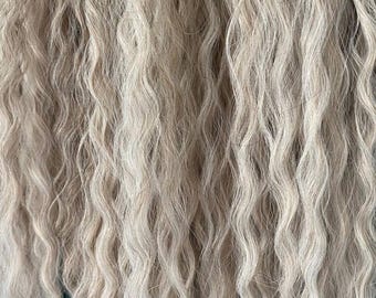 Long wavy light blonde synthetic hair extensions, loose flowing waves synthetic locks hair, voluminous light ashy blonde soft curly dreads