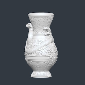 May include: White ceramic vase with a detailed relief design. Two snakes are wrapped around the vase, with their heads near the top. The vase has a wide base and a flared top, and is decorated with floral and geometric patterns.