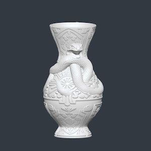 May include: White ceramic vase with a detailed relief design. A snake is coiled around the vase, adding a unique decorative element. The vase features intricate patterns and a flared top, suitable for home decor.