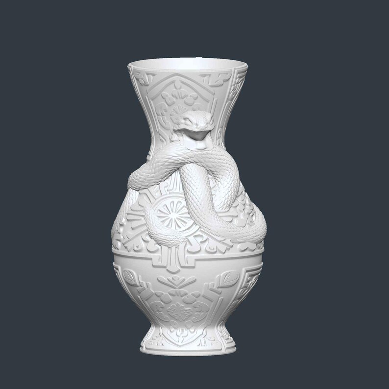 May include: White ceramic vase with a detailed relief design. A snake is coiled around the vase, adding a unique decorative element. The vase features intricate patterns and a flared top, suitable for home decor.