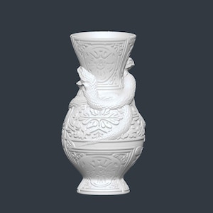 May include: White decorative vase with a detailed relief pattern and two snakes coiled around the body. The vase has a flared top and a pedestal base. The design features floral and geometric elements.
