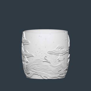May include: A white, cylindrical drinking glass with an embossed design featuring mushrooms, flowing water, and stars. The design is raised, creating a textured surface. The glass has a smooth, rounded rim and a dark background.