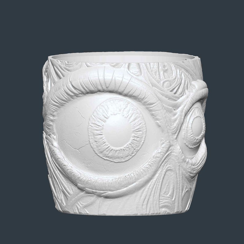 May include: White cylindrical container with a detailed relief of two large eyes and surrounding organic textures. The design features intricate details, creating a unique and artistic aesthetic. The container is likely made of ceramic or a similar material.