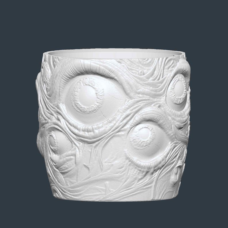 May include: White cylindrical plant pot with a textured surface featuring multiple eye designs. The pot has a wide opening and is made of a solid, opaque material. The design is a unique, artistic representation.