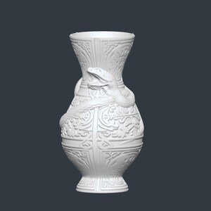 May include: A white decorative vase with an ornate design and a snake wrapped around the body. The vase has a wide base and a flared top. The snake is detailed with scales and a raised head.