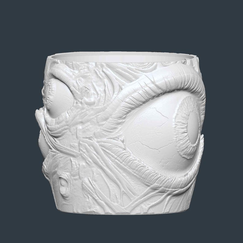 May include: A white, cylindrical planter with a detailed, textured design featuring large, stylized eyes and organic, vein-like patterns. The planter has a wide opening and a smooth rim, suitable for indoor or outdoor use.