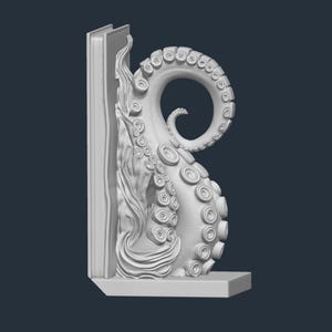 May include: A white octopus tentacle bookend with a detailed design. The tentacle curves upwards, with a section of a book on the left side. The bookend is designed to hold books upright on a shelf.