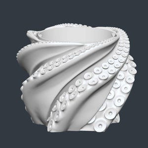 May include: A white, stylized octopus-themed container. The design features swirling tentacles forming the body, with suction cups visible. The top has a circular opening. The overall shape is reminiscent of a vase or bowl.