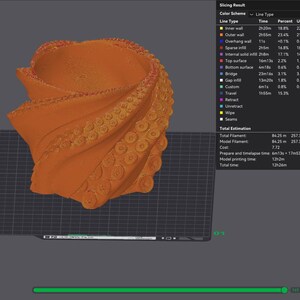 May include: An orange 3D-printed vase with a spiral design and textured details. The vase is displayed on a dark gray surface, with a 3D printing software interface visible in the background, showing printing details.