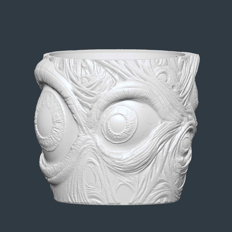 May include: White, cylindrical plant pot with a textured surface featuring multiple eye designs. The pot has a wide opening and is made of a solid, opaque material. The design is detailed and appears to be carved or moulded.