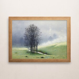May include: A framed painting depicting a misty landscape with a stream winding through a field of wildflowers. A group of trees stand in the foreground, their branches reaching towards the sky. The painting is done in a realistic style with soft, muted colors.