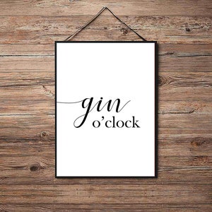 May include: A black and white printable wall art print with the text "gin o'clock" in a cursive font.