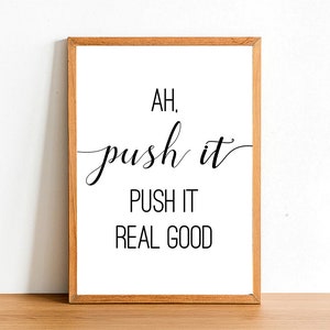 May include: A framed print with the text "AH. push it PUSH IT REAL GOOD" in black cursive font on a white background.