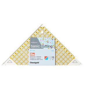 May include: A clear plastic triangular quilting ruler with yellow and black grid markings and a hanging hole at the top. The ruler features a label with the text Handbook for basic cutting, 611 314, Prym, and Triangle for 1/2 squares 15 cm.